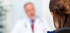 Woman sitting down with doctor